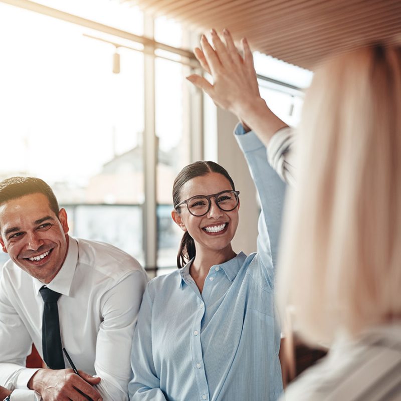 web-laughing-businesswomen-high-fiving-together-in-an-2021-08-27-09-29-52-utc